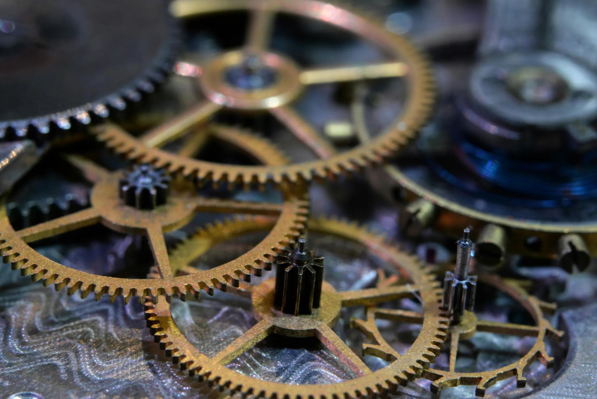 Close macro view of brass and steel gear wheels from a fine mechanical watch movement
