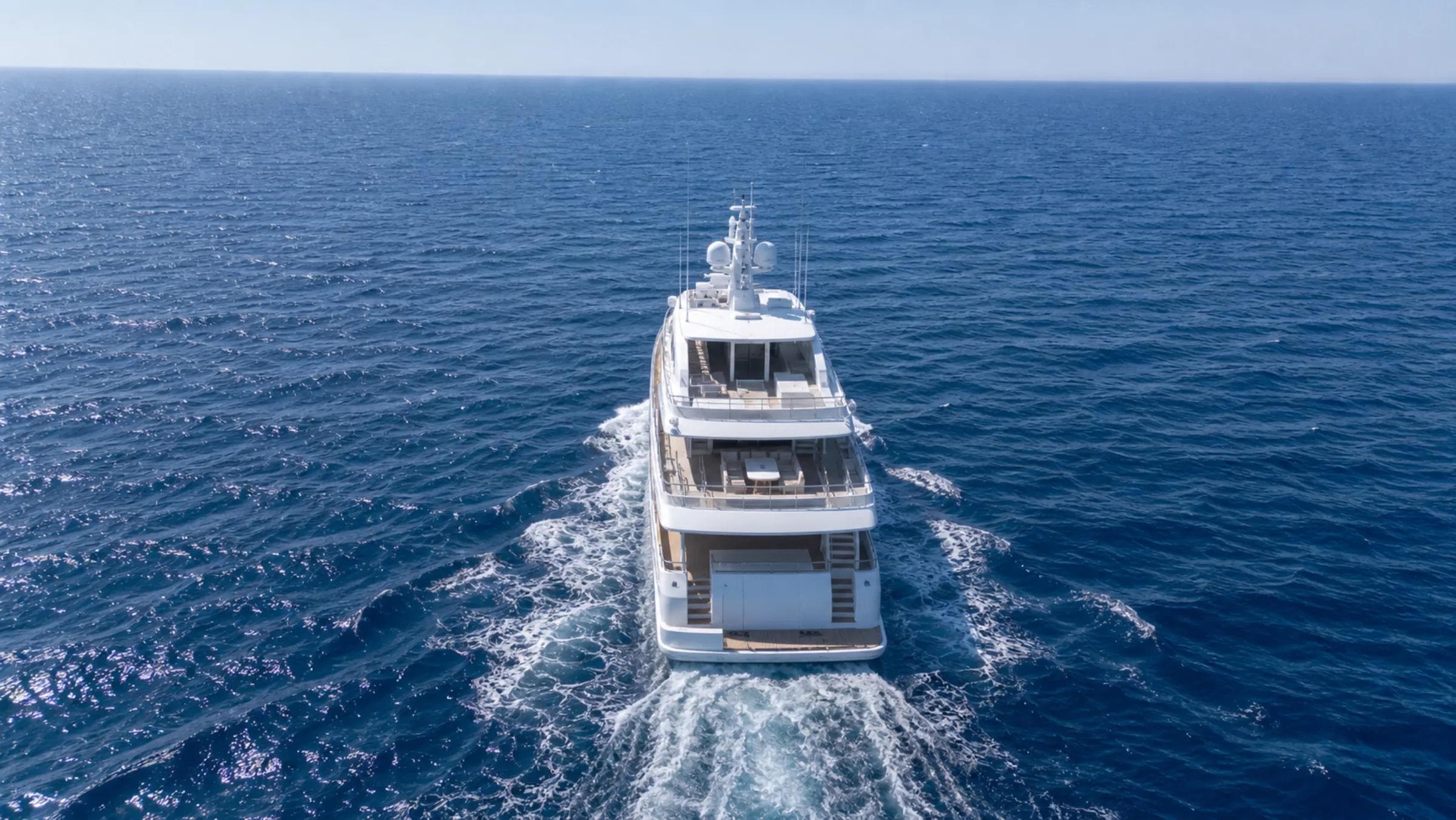 Mediterranean superyacht cruising at sea on a clear afternoon